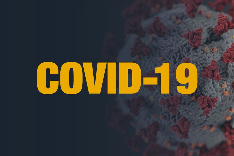 A dark blue graphic, featuring an image of the COVID-19 virus with text that reads "COVID-19"